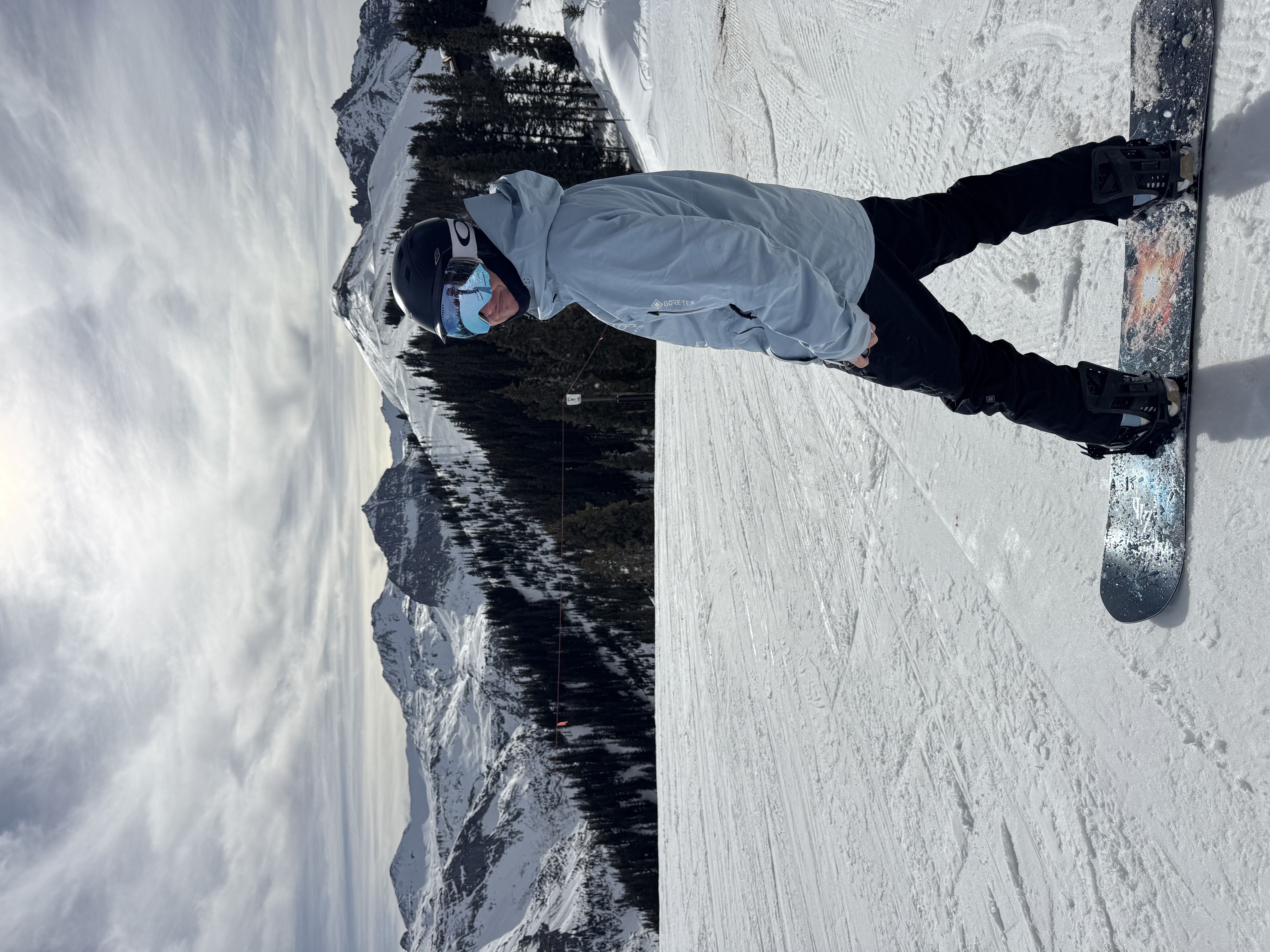 Snowboarder on Telluride slopes with San Juan Mountains